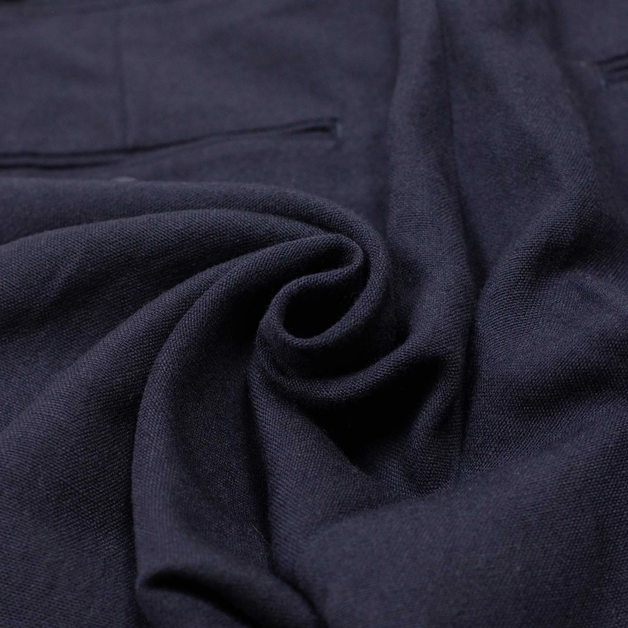 Side tab pleated trousers in dark navy soft wool and linen oxford